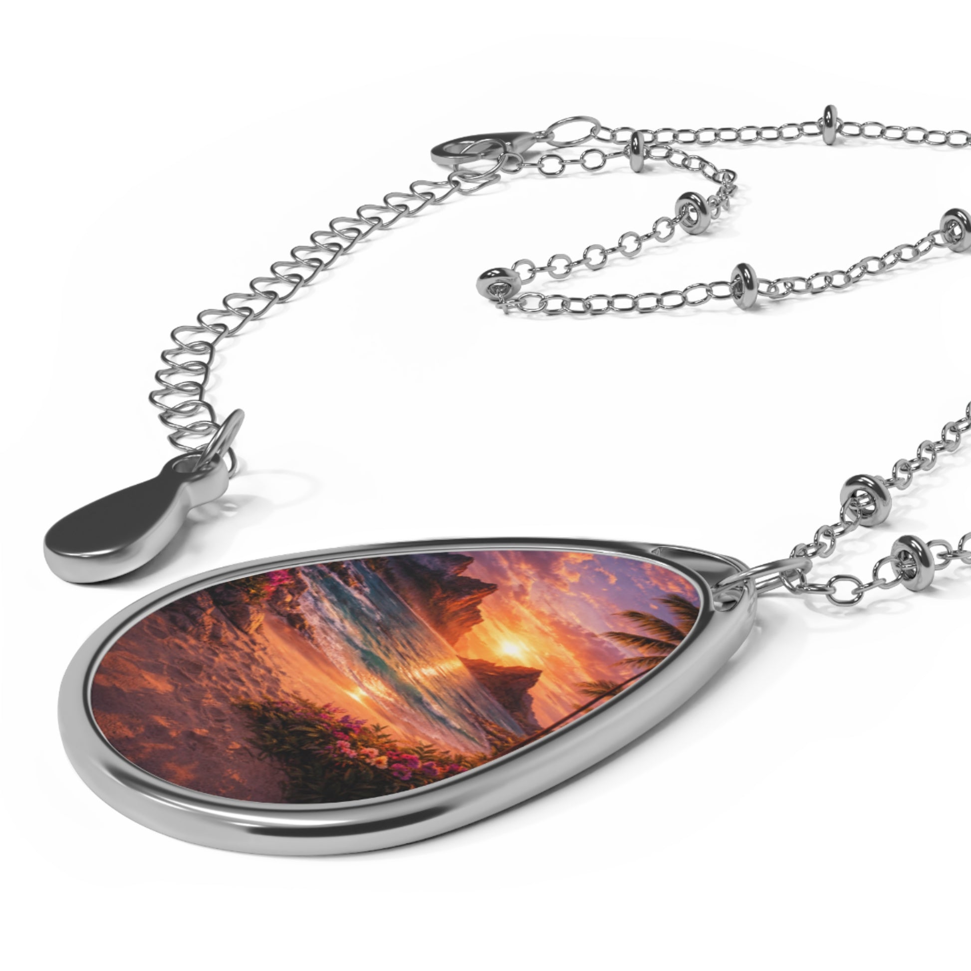 Teardrop-shaped pendant with a fiery landscape design on a white background