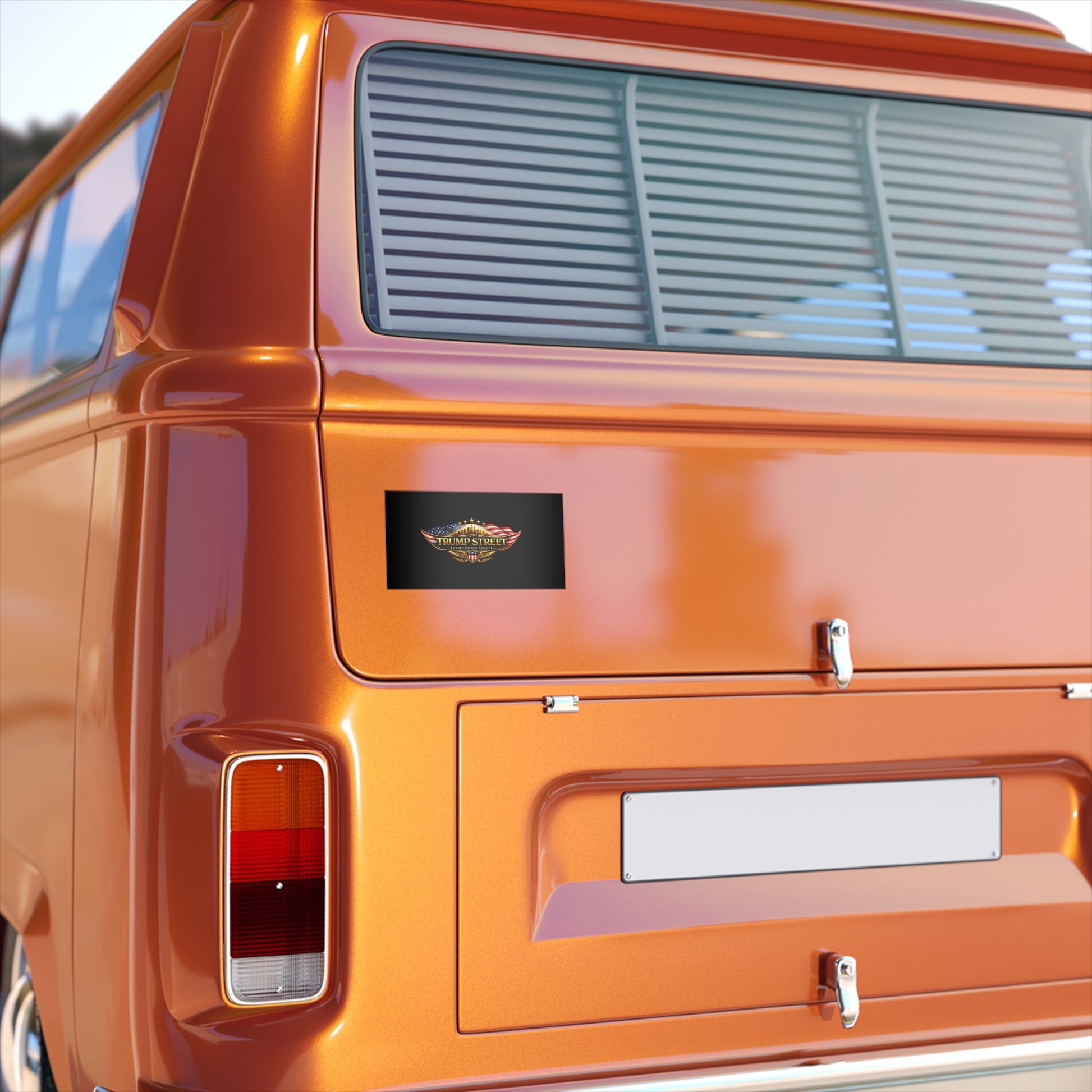 Close-up of an orange vehicle's rear end with a visible logo.