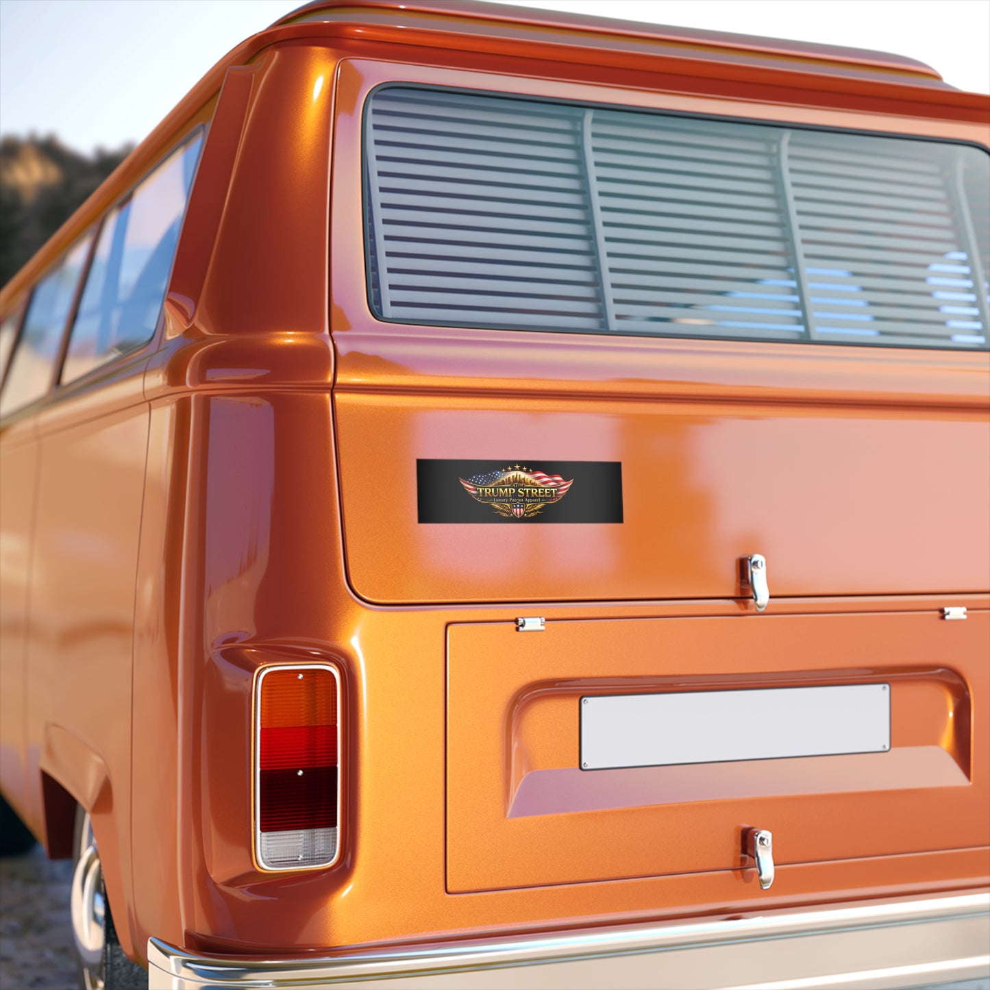Close-up of an orange vintage van with a visible logo on the back door.