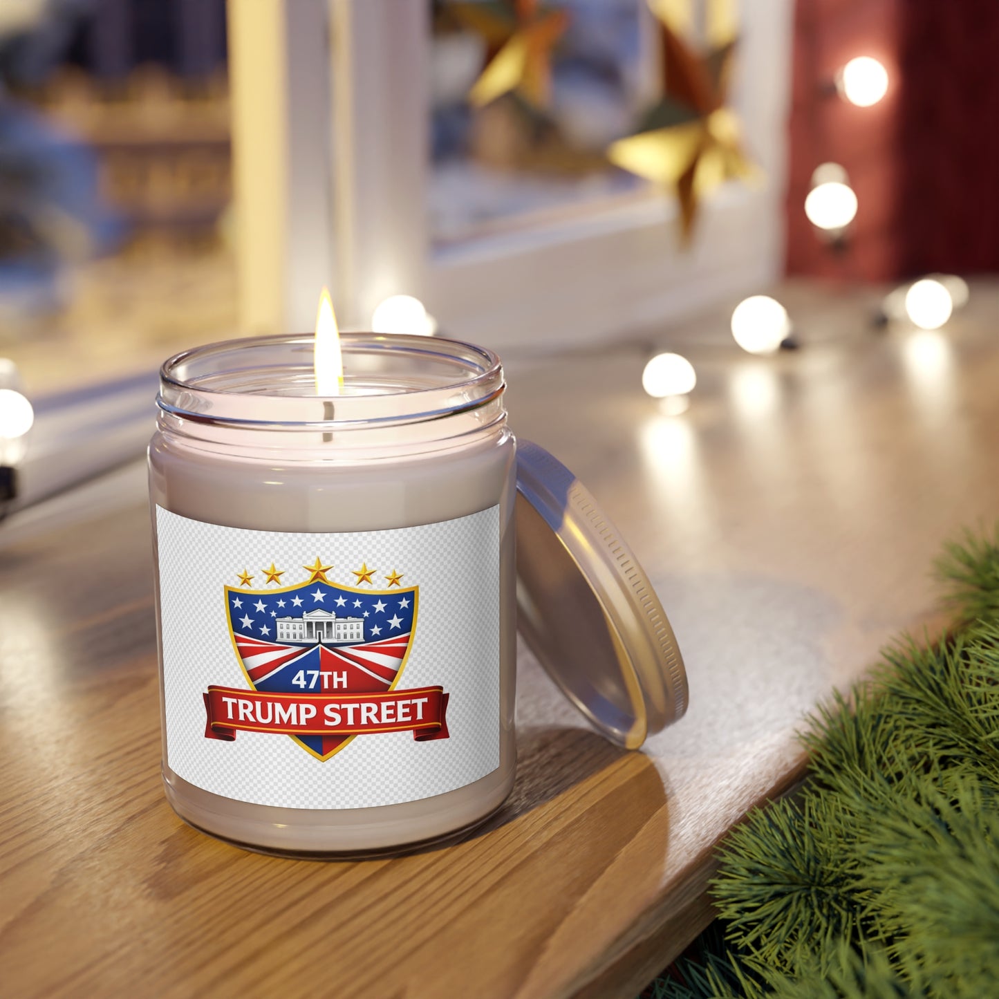 Candle in a jar with a 'Trump Street' label on a wooden surface with decorative lights in the background.