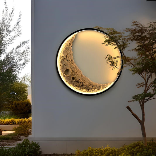 crescent moon LED wall light illuminated on exterior wall at night