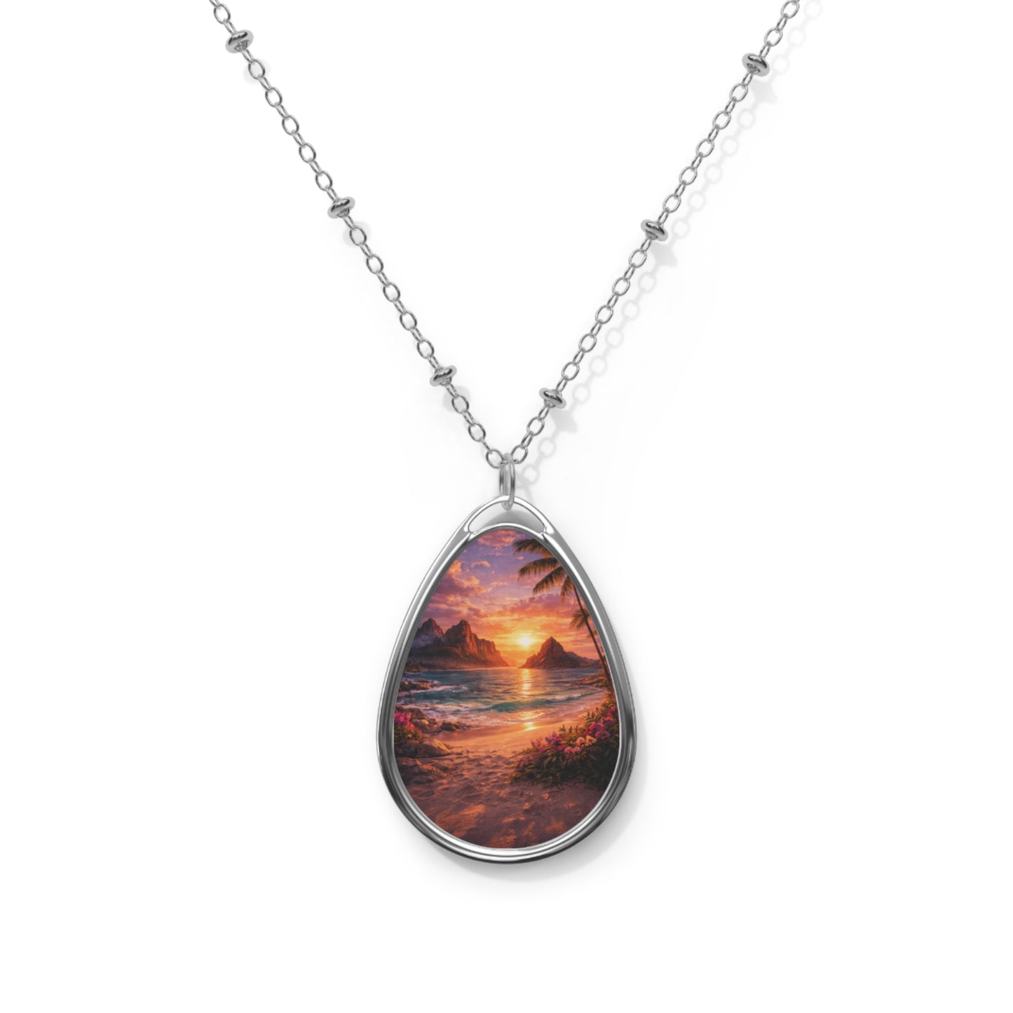 Teardrop-shaped pendant with sunset over water design on a white background