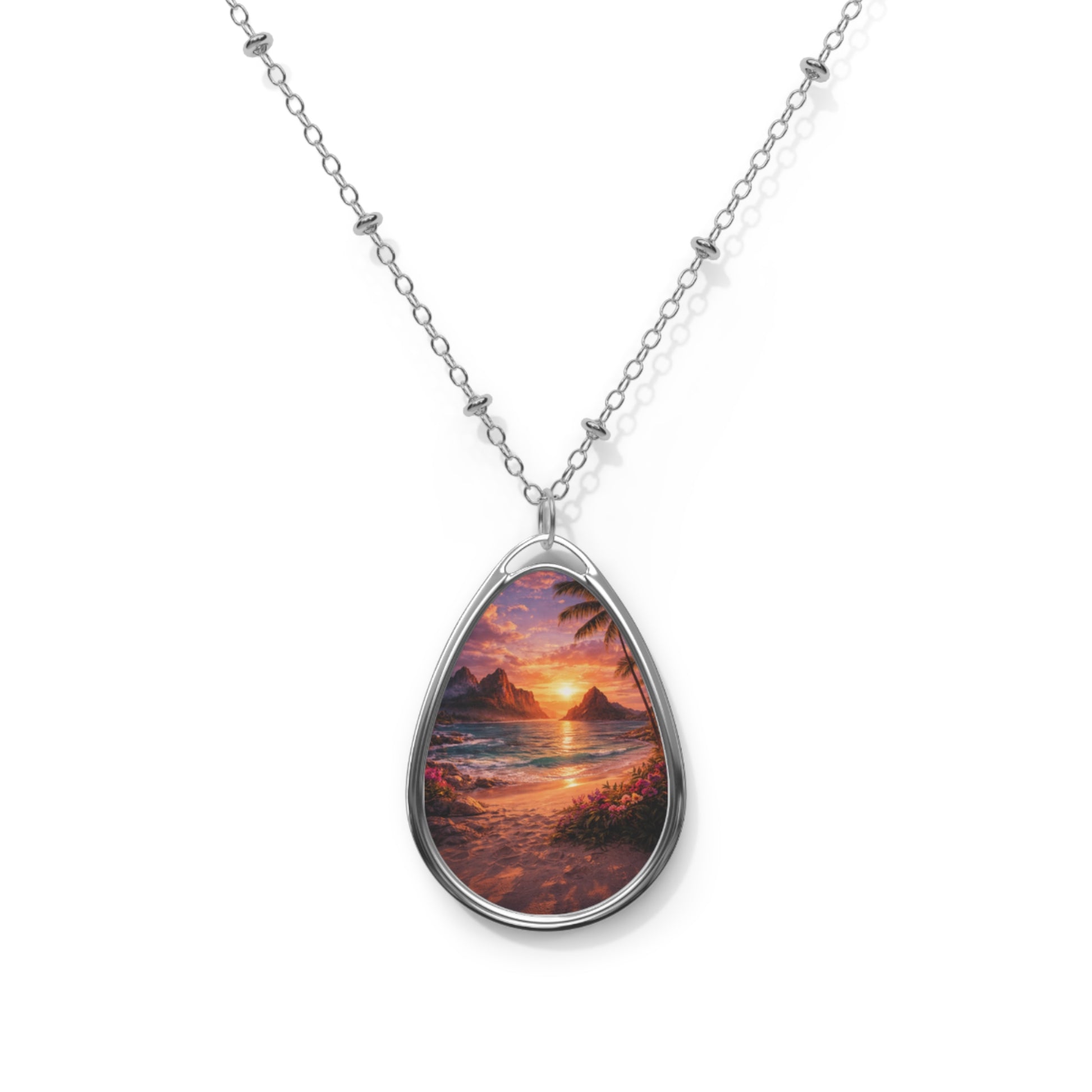Teardrop-shaped pendant with sunset over water design on a white background