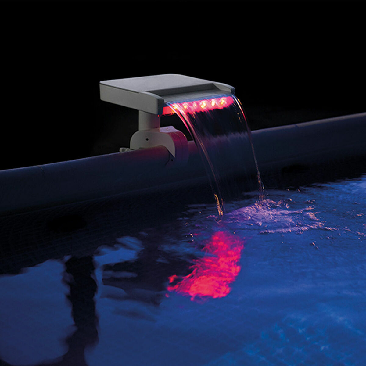 Solar pool light emitting red light into a pool at night