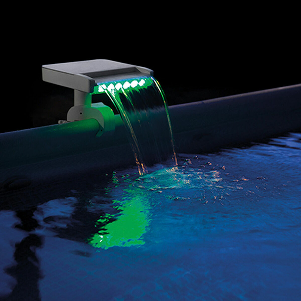 Solar pool light with water feature on a pool edge at night