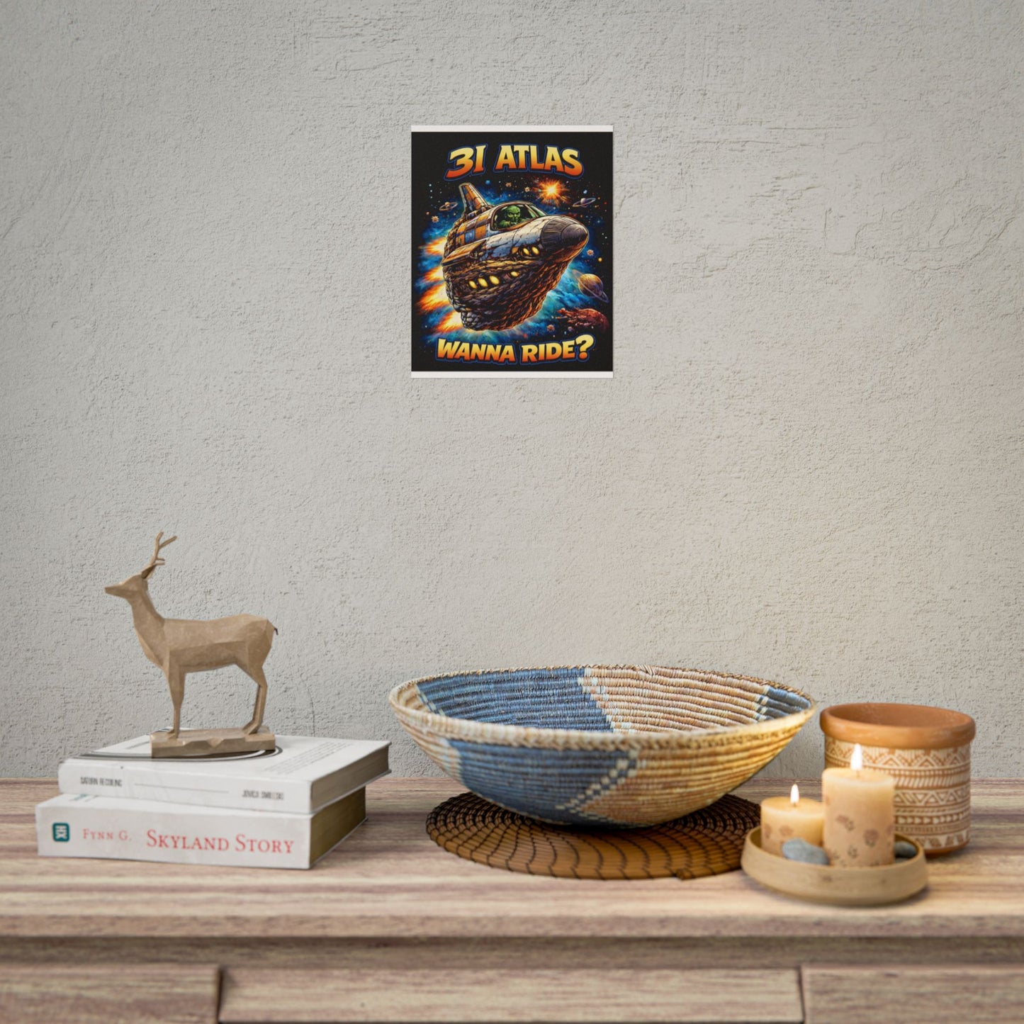 Decorative setup with a poster on the wall, books, a bowl, and candles on a wooden surface.