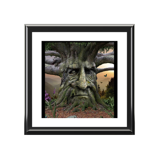 Framed artwork of a tree-like creature with a face against a natural background