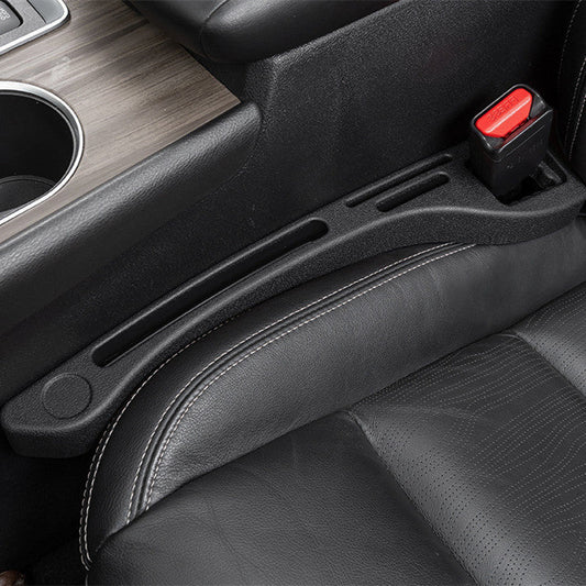 Car interior with a black armrest and cup holder.
