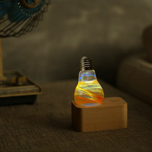 Decorative light bulb on a wooden base with a blurred background