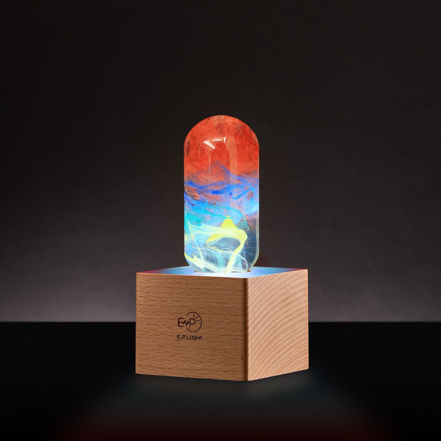 Colorful glass object on a wooden base with a dark background