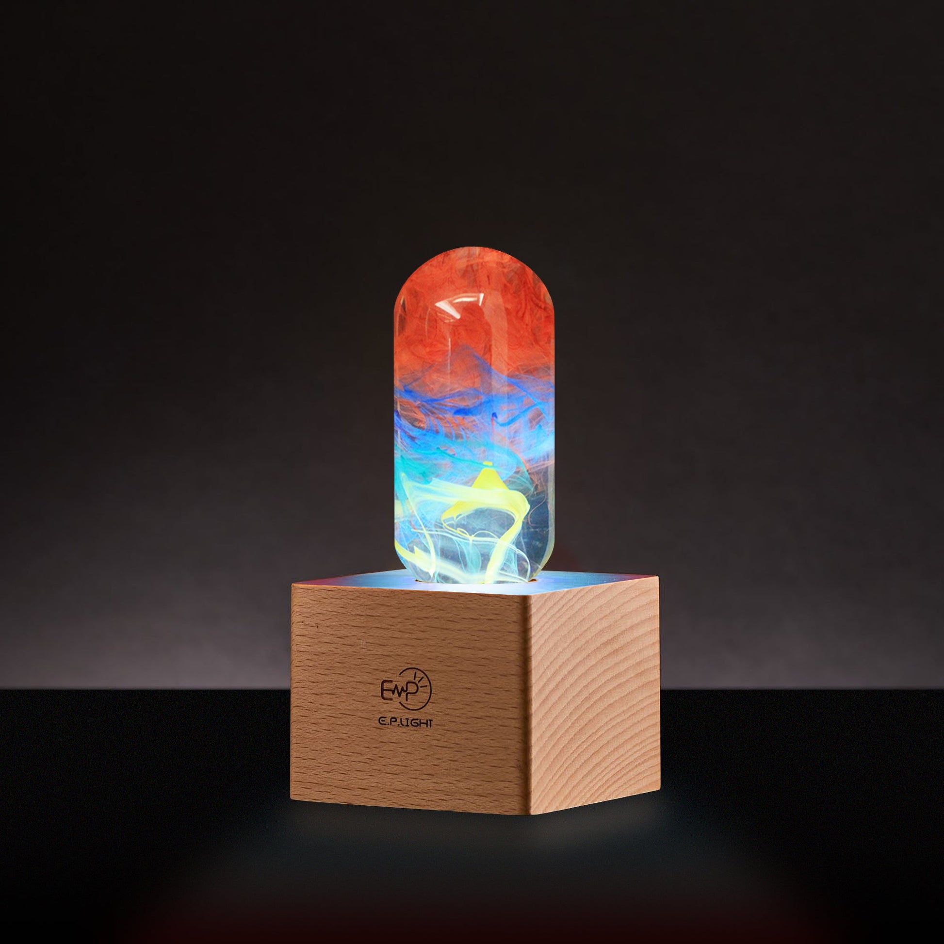 Colorful glass object on a wooden base with a dark background