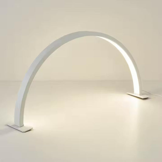 Modern white arch-shaped lamp on a light gray background