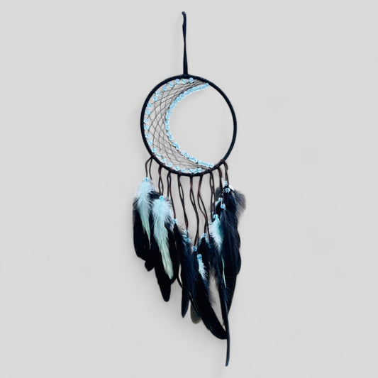 crescent moon dream catcher with black and light blue feathers hanging on wall boho decor