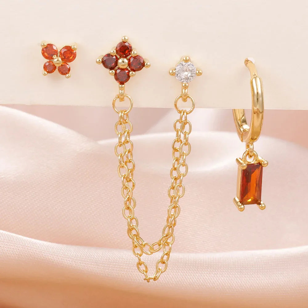 Celestial zodiac birthstone earring set in gold with gemstone accents and elegant chain detail