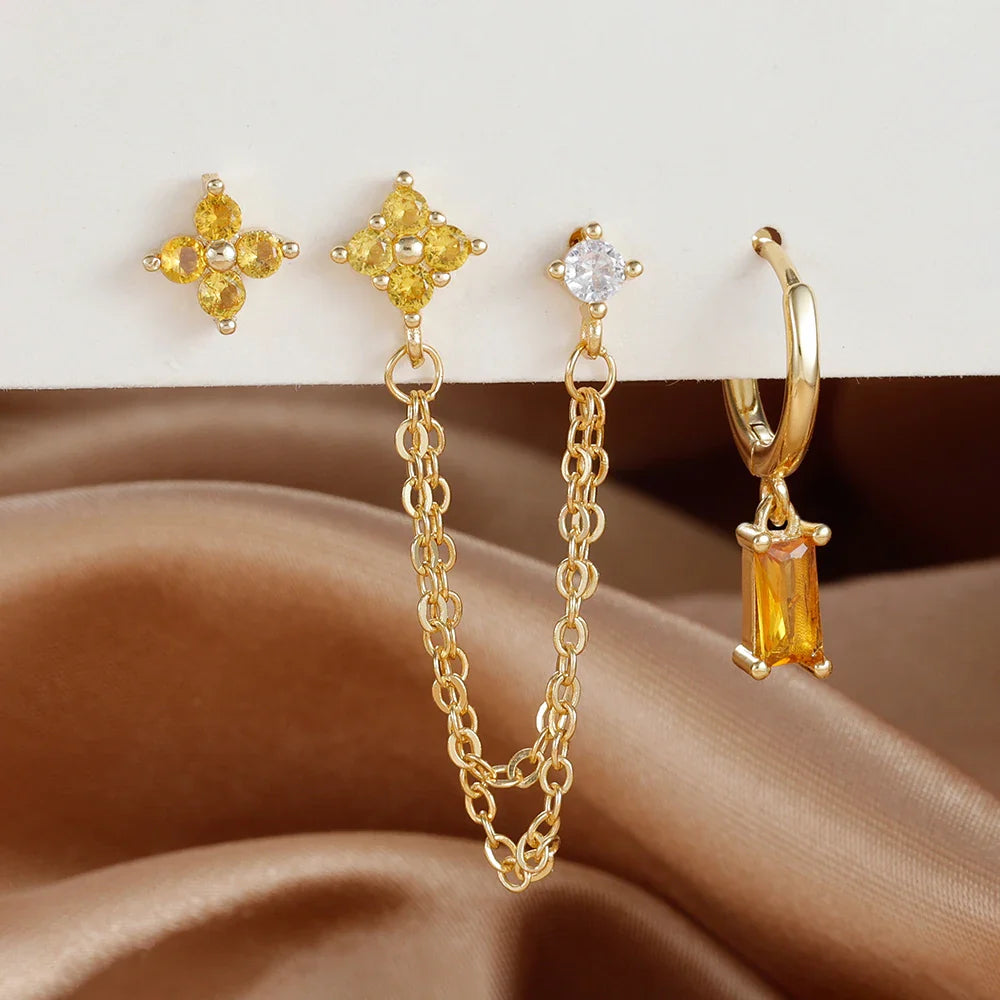 Celestial zodiac birthstone earring set in gold with gemstone accents and elegant chain detail