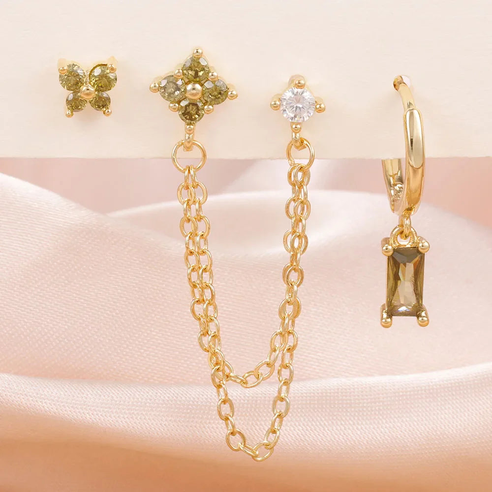 Celestial zodiac birthstone earring set in gold with gemstone accents and elegant chain detail