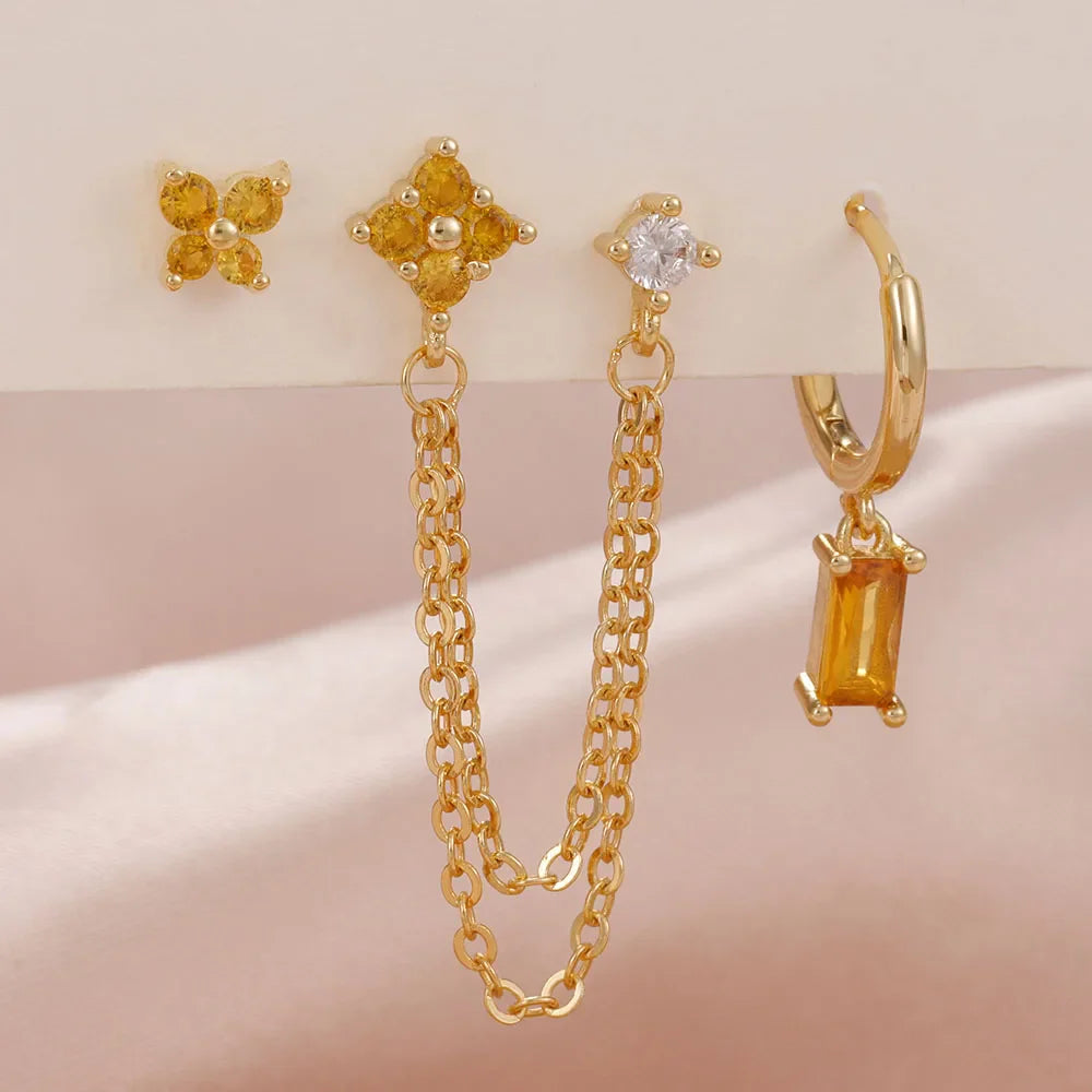 Celestial zodiac birthstone earring set in gold with gemstone accents and elegant chain detail