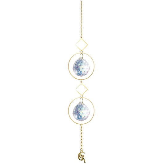 Celestial crystal sun catcher wind chime with moon and star design creating rainbow light reflections in window