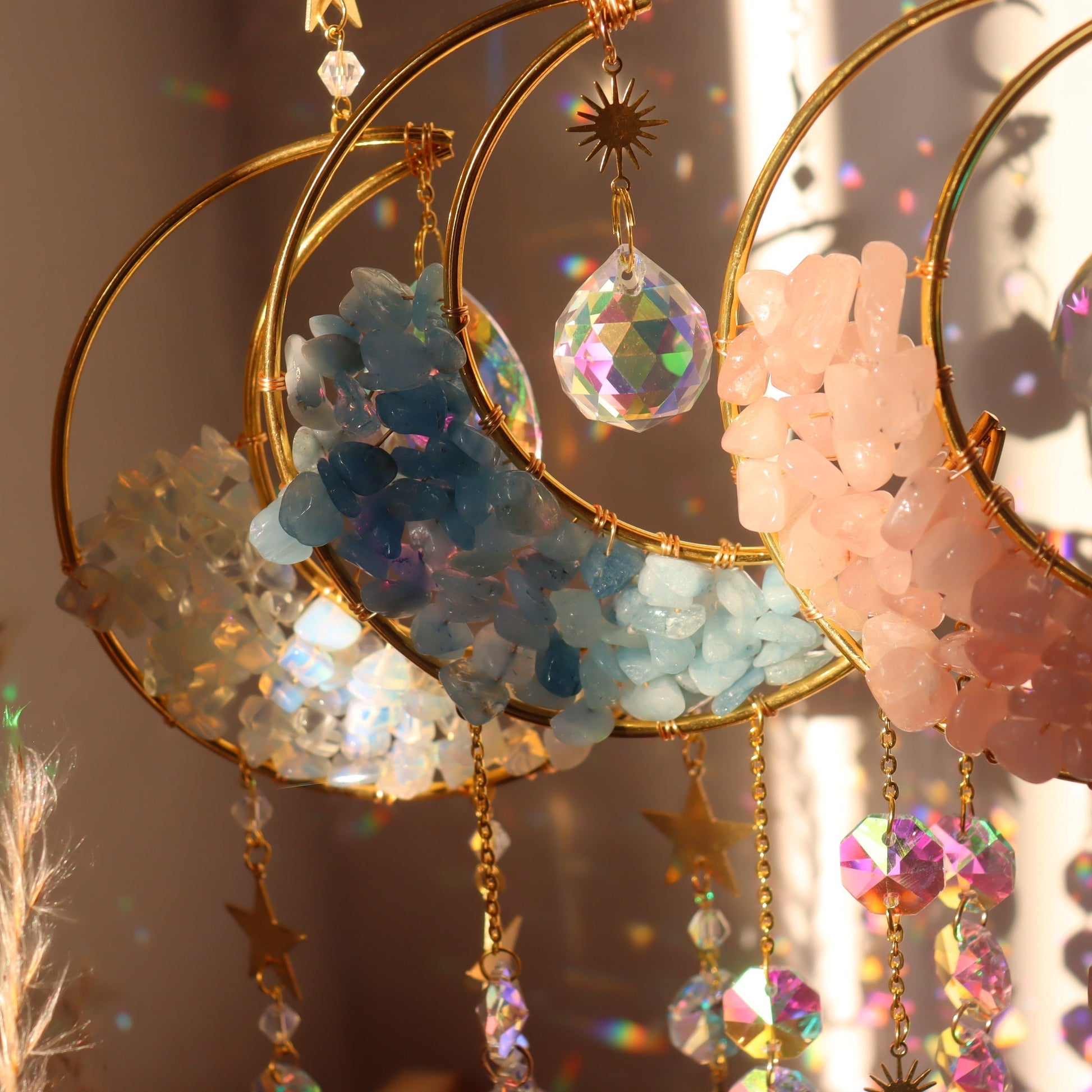 crescent moon crystal wind chime reflecting sunlight rainbow prisms