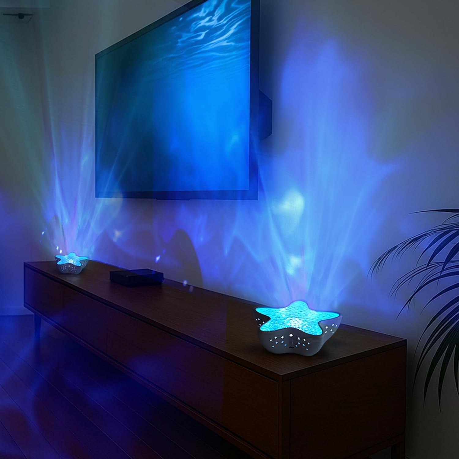 Galaxy star projector light casting blue nebula and star effects in a dark room